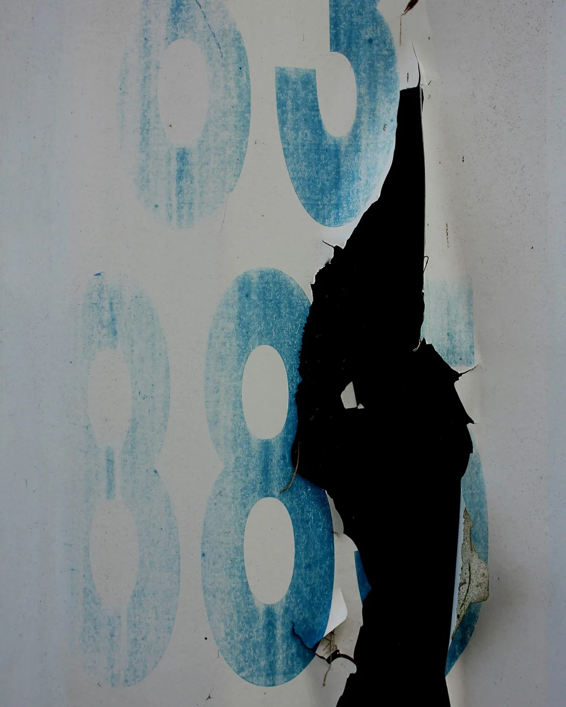 A torn poster — identity fails at the seams